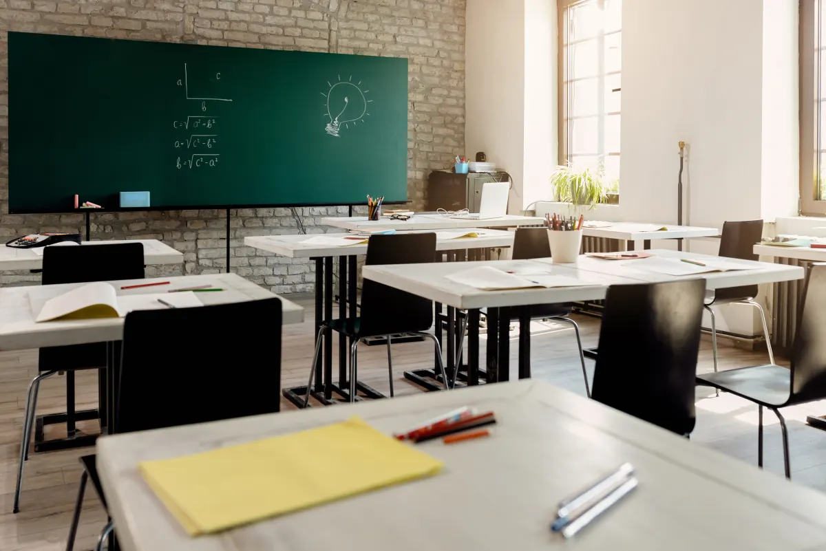 Sunlight across desks in an empty classroom.